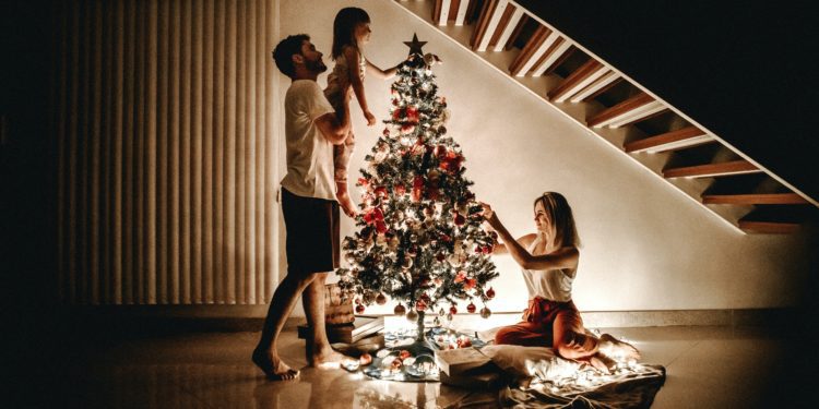 Família decorando a árvore de Natal